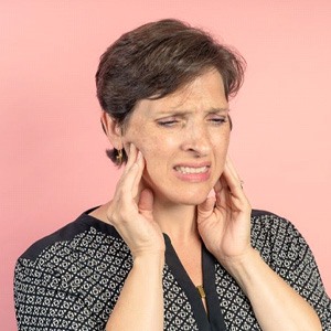 Middle-aged woman suffering from TMJ pain