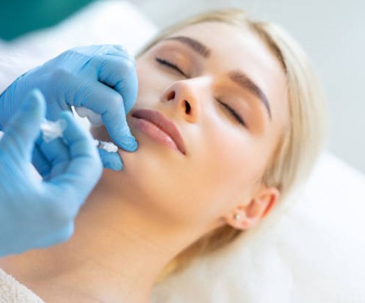 Woman receiving a facial injection