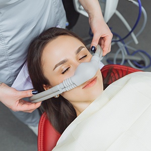 Placing mask over patient’s nose for nitrous oxide sedation