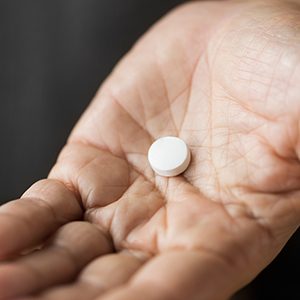 Close up of pill sitting in palm of hand